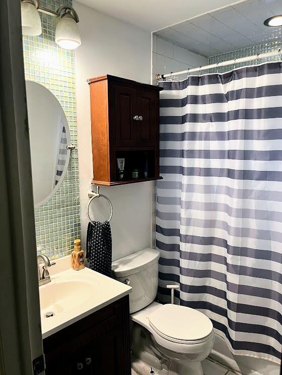 bathroom featuring vanity and toilet