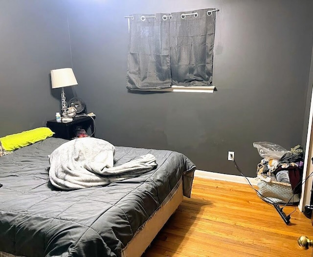 bedroom with hardwood / wood-style floors