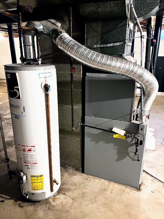 utility room featuring gas water heater