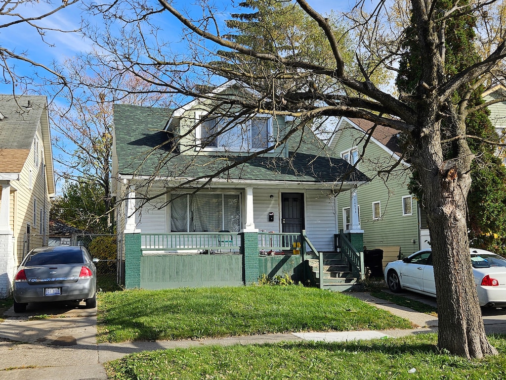 view of front of home with a front yard and a porch