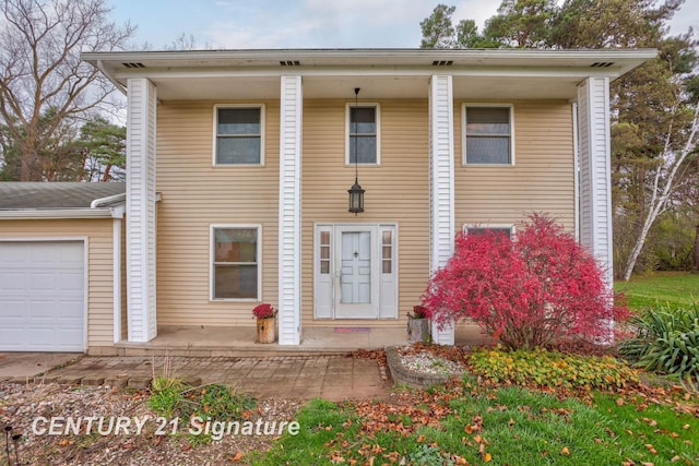 view of front of property with a porch and a garage