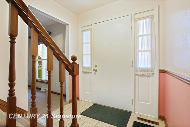 foyer entrance with light tile patterned flooring