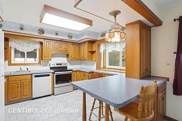 kitchen with dishwasher, sink, hanging light fixtures, kitchen peninsula, and electric stove