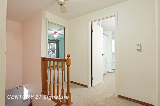 corridor featuring light colored carpet