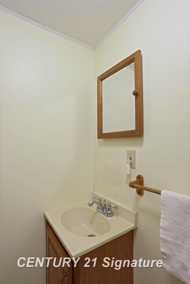 bathroom featuring vanity and ornamental molding