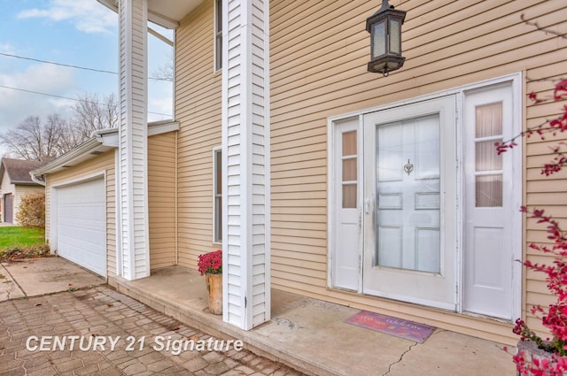 view of exterior entry featuring a garage