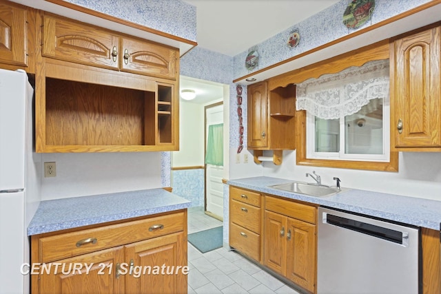 kitchen with stainless steel dishwasher, white refrigerator, light tile patterned floors, and sink