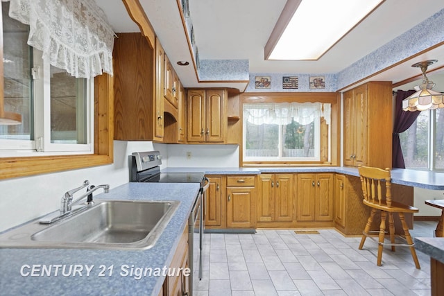 kitchen featuring stainless steel range with electric cooktop and sink