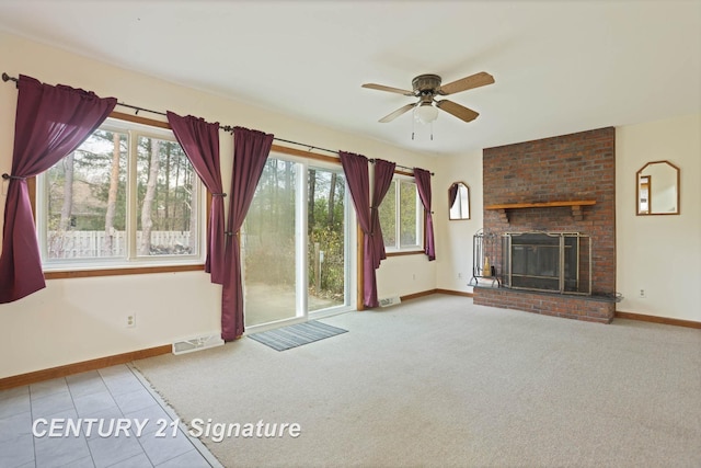 unfurnished living room with a fireplace, carpet flooring, a wealth of natural light, and ceiling fan