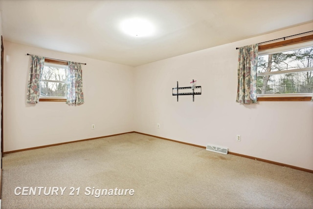 empty room featuring carpet and a healthy amount of sunlight