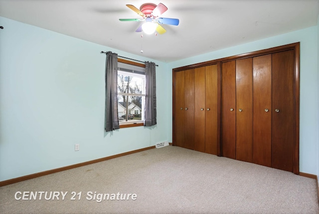 unfurnished bedroom with carpet floors, a closet, and ceiling fan