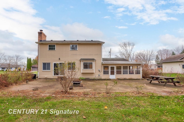 rear view of house featuring a patio area and a sunroom