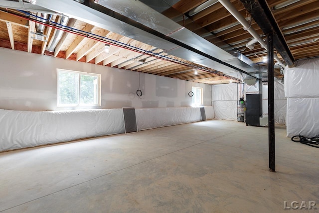 basement with water heater and heating unit