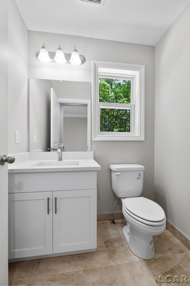 bathroom with toilet and vanity