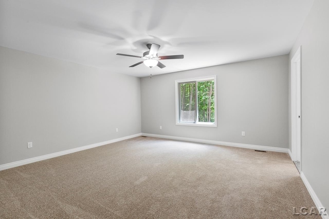 carpeted empty room with ceiling fan