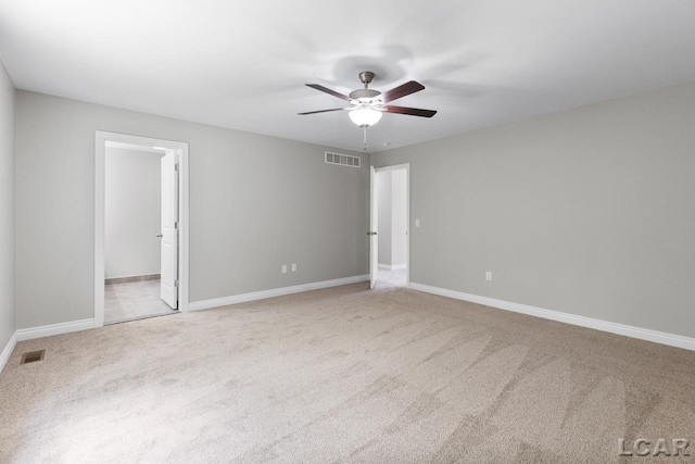 empty room with ceiling fan and light colored carpet