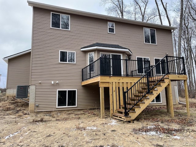 back of property featuring central air condition unit and a deck