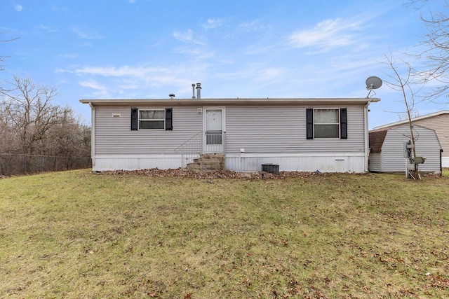 rear view of property featuring a yard