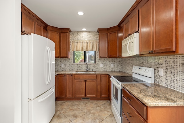 kitchen featuring light stone countertops, sink, tasteful backsplash, white appliances, and light tile patterned flooring