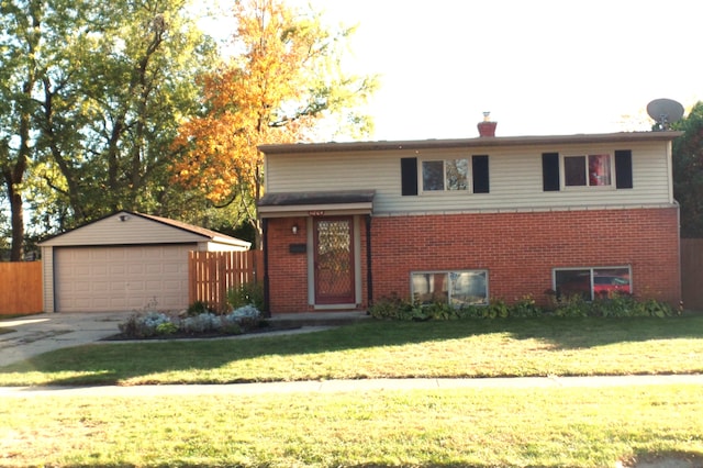 split level home featuring a garage, an outdoor structure, and a front yard