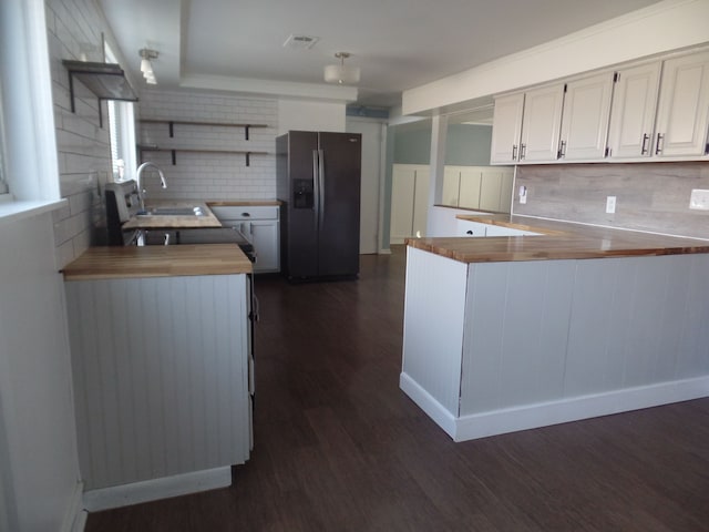 kitchen featuring sink, stainless steel fridge with ice dispenser, dark hardwood / wood-style floors, kitchen peninsula, and white cabinets