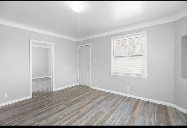 unfurnished room with hardwood / wood-style flooring