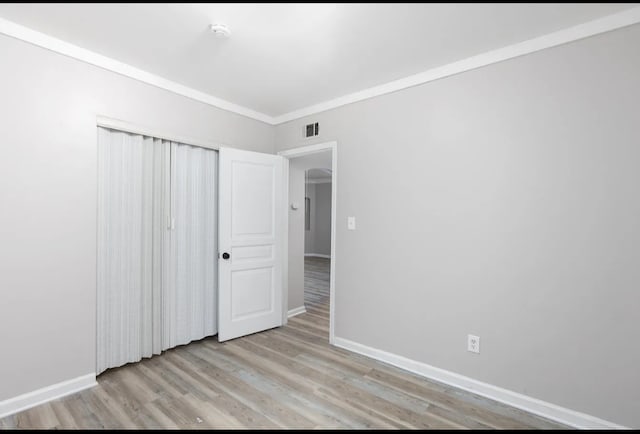 unfurnished bedroom featuring a closet and light hardwood / wood-style floors