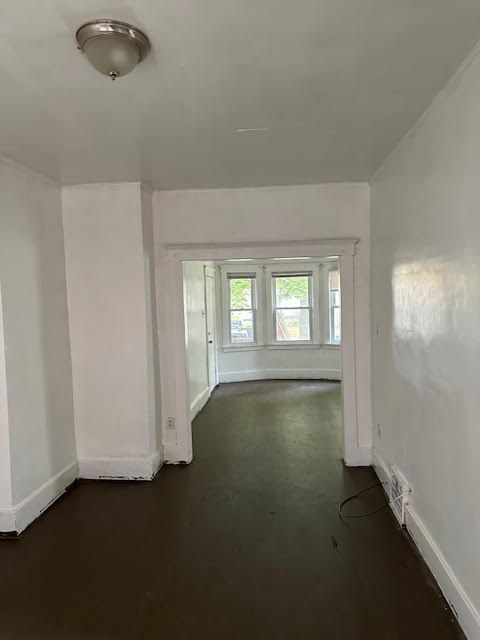 unfurnished room with baseboards