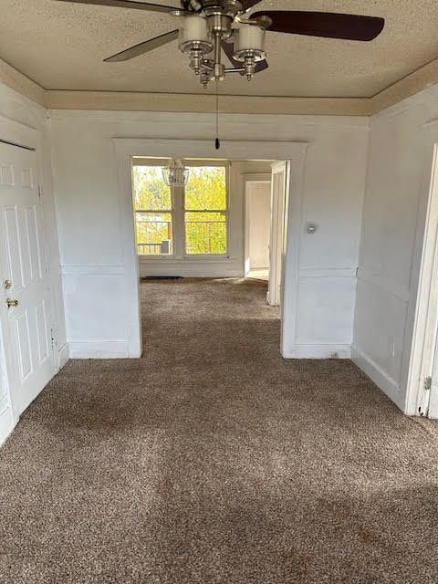 spare room featuring carpet floors and a textured ceiling