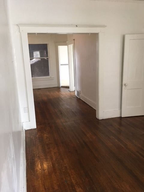 hallway featuring dark hardwood / wood-style flooring