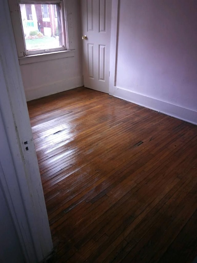 spare room featuring dark wood-type flooring