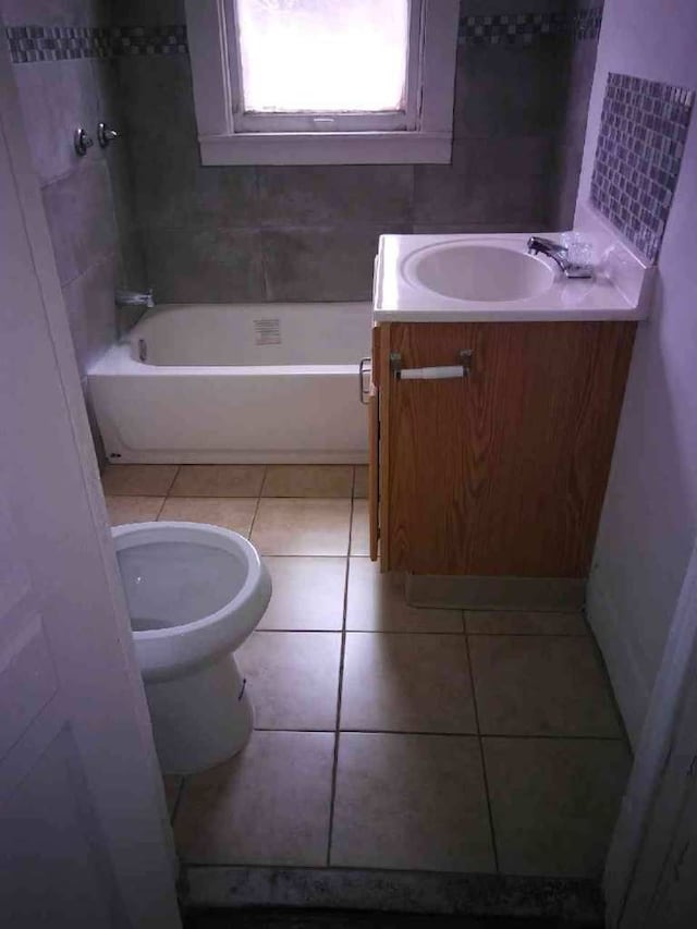 bathroom with toilet, vanity, and tile patterned floors