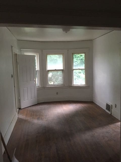 spare room featuring dark hardwood / wood-style flooring