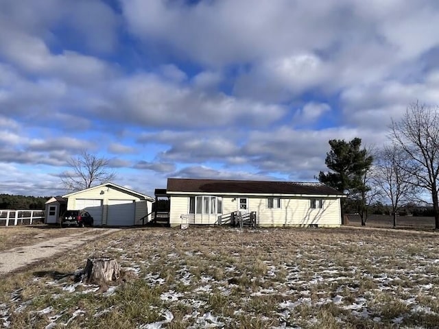 view of front facade with an outbuilding and a garage