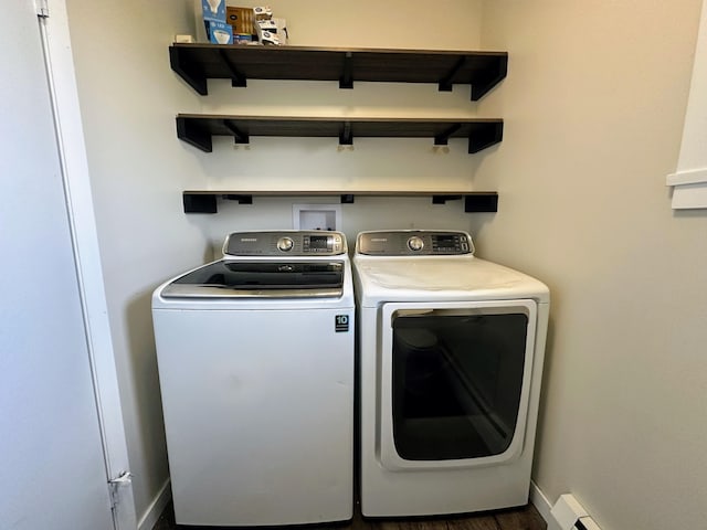 laundry room featuring washer and clothes dryer, dark hardwood / wood-style flooring, and a baseboard radiator