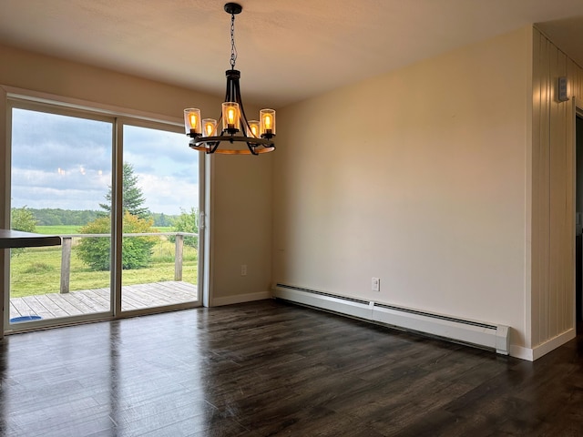 spare room featuring dark hardwood / wood-style flooring, a baseboard radiator, and a notable chandelier