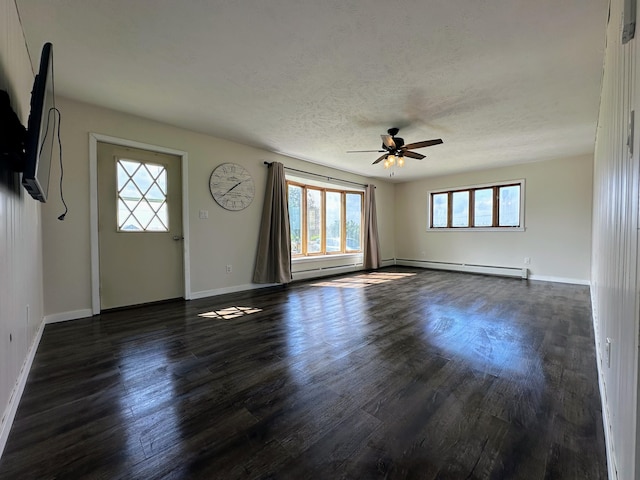 interior space featuring dark wood-type flooring, a baseboard radiator, and a healthy amount of sunlight