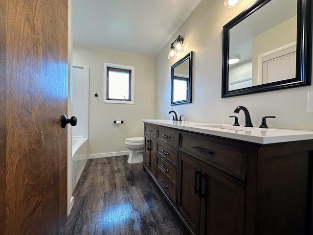 bathroom featuring hardwood / wood-style flooring, vanity, and toilet