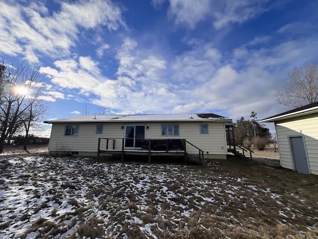 snow covered property with a wooden deck