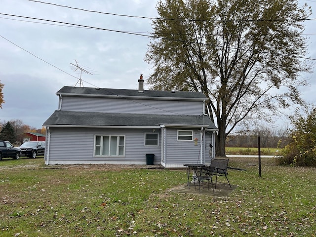 back of property featuring a lawn