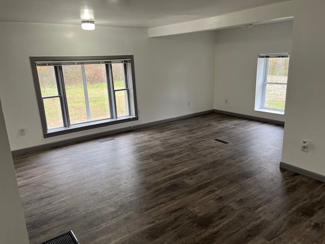 empty room featuring dark wood-type flooring