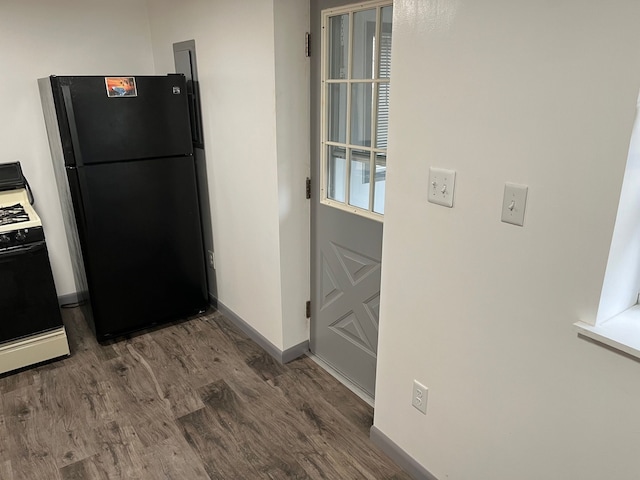 kitchen featuring dark hardwood / wood-style flooring and black appliances