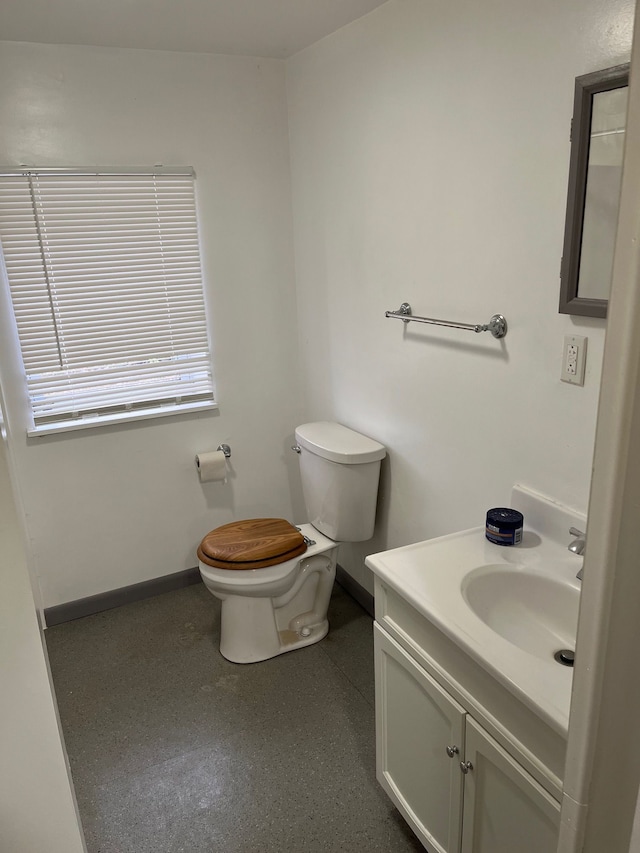 6801 Ravenswood Rd, Kimball, MI 48074 - half bathroom featuring toilet, vanity, and baseboards