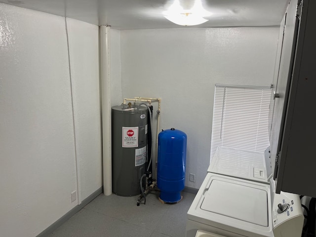 clothes washing area featuring washer / dryer and water heater