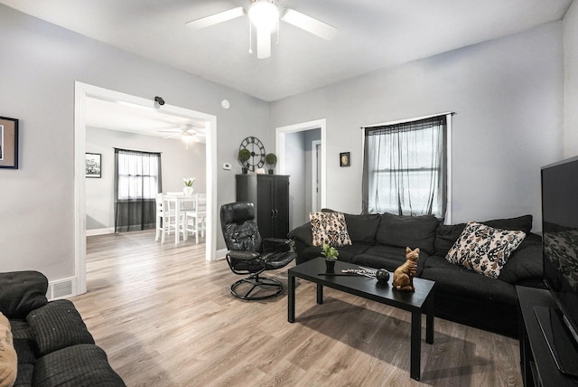 living room featuring plenty of natural light, light hardwood / wood-style floors, and ceiling fan