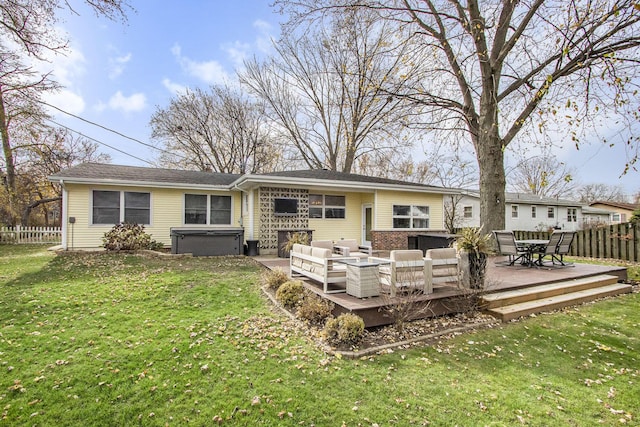 back of property with a deck, an outdoor hangout area, a yard, and a hot tub