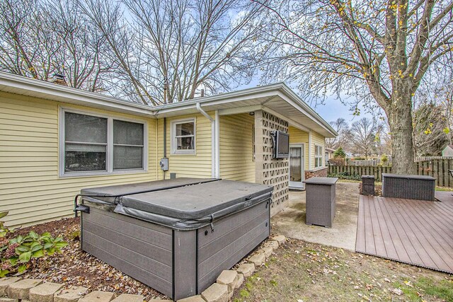 wooden deck featuring a hot tub