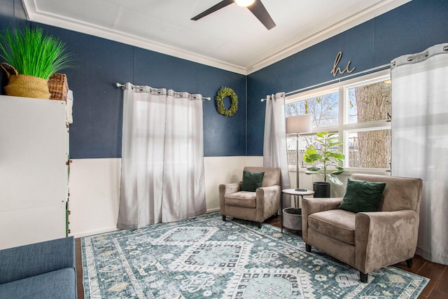 living area with hardwood / wood-style floors, ceiling fan, and crown molding