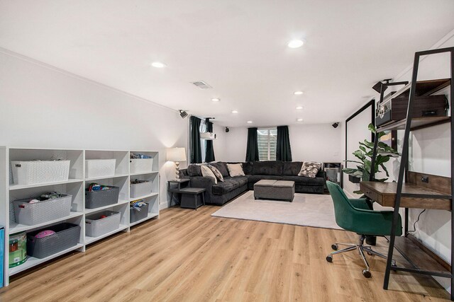 office space featuring crown molding and light hardwood / wood-style flooring