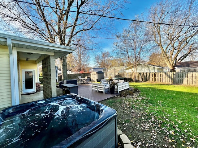 view of yard featuring an outdoor living space, a hot tub, and a storage unit